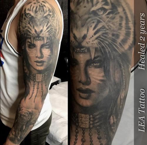 Woman with Tiger headdress. Part of a sleeve in black & gray.